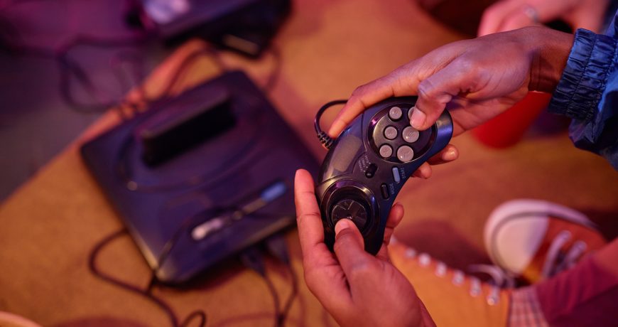 Top view closeup of black young man playing retro video game